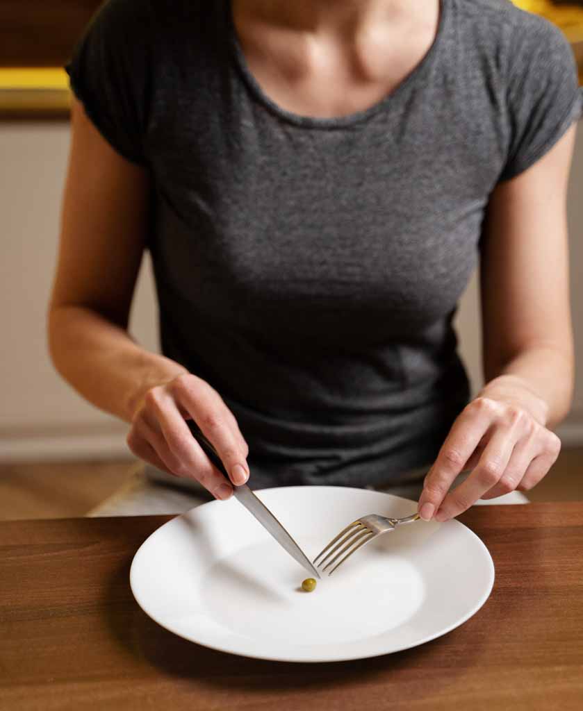 woman-with-eating-disorder-having-pea-her-plate