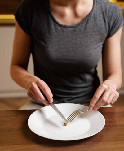 woman-with-eating-disorder-having-pea-her-plate